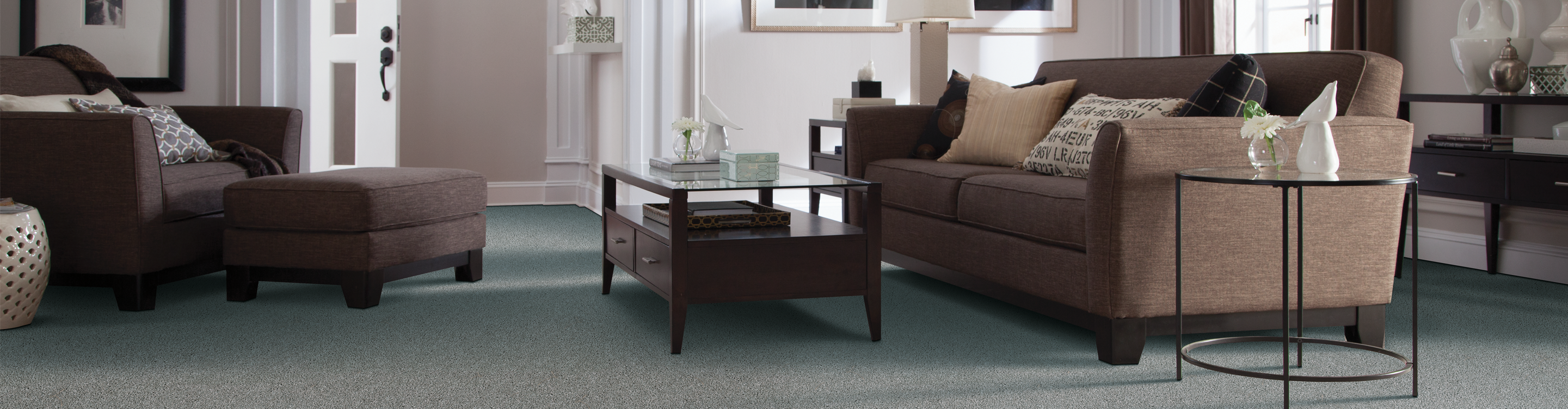 Green Berber style carpet in living room with brown chair.